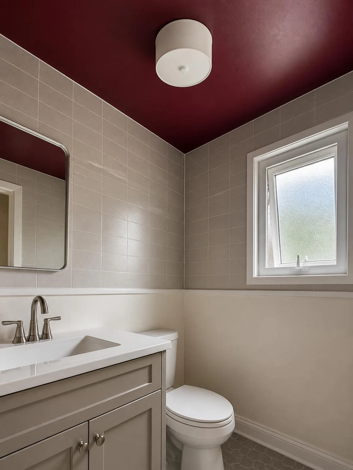 Compact bathroom with deep burgundy painted ceiling above warm gray tile walls, showing how bold ceiling color transforms small bathroom decor on a budget