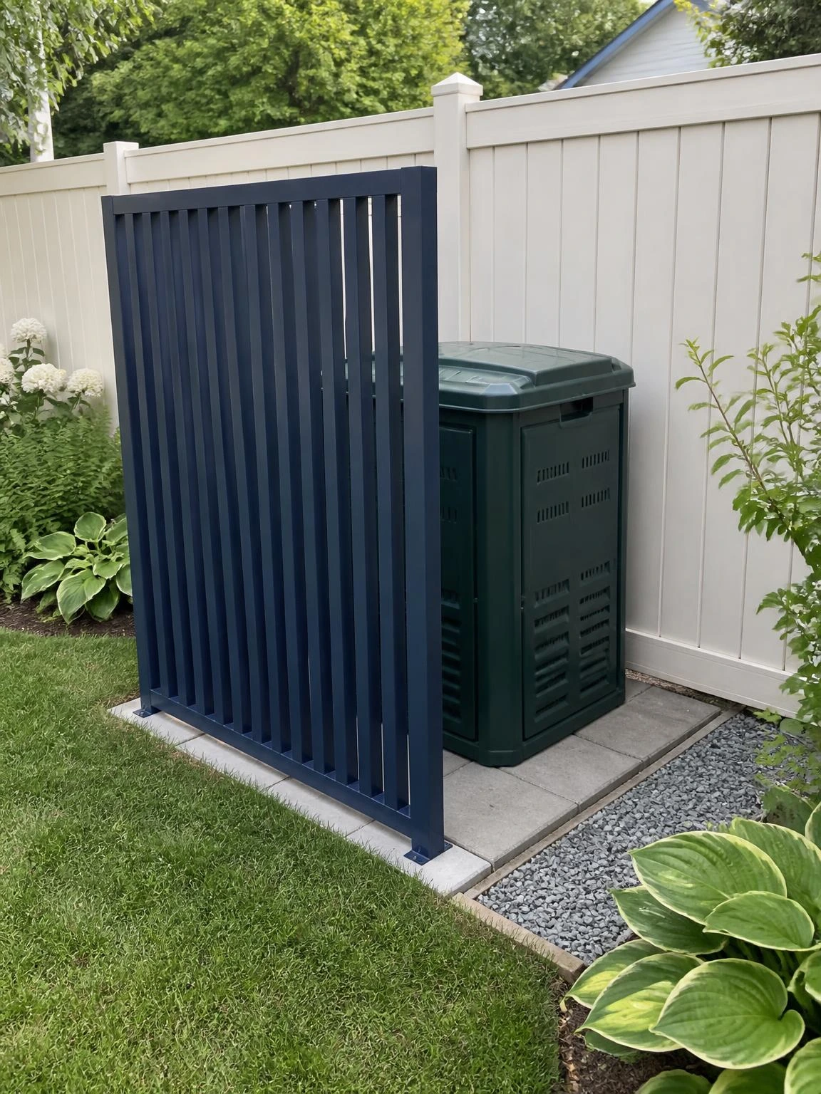 Screened compost bin behind a navy slatted screen on a tidy paver pad, showing practical access for DIY garden projects