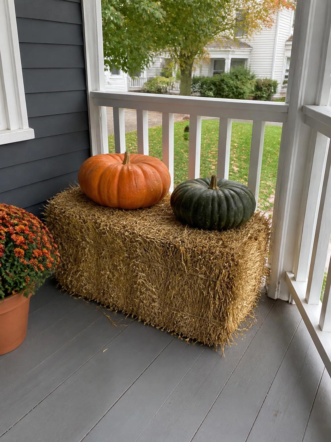 10- Hay Bale Seat with Flat Pumpkin Arrangement - halloween porch ideas for small spaces