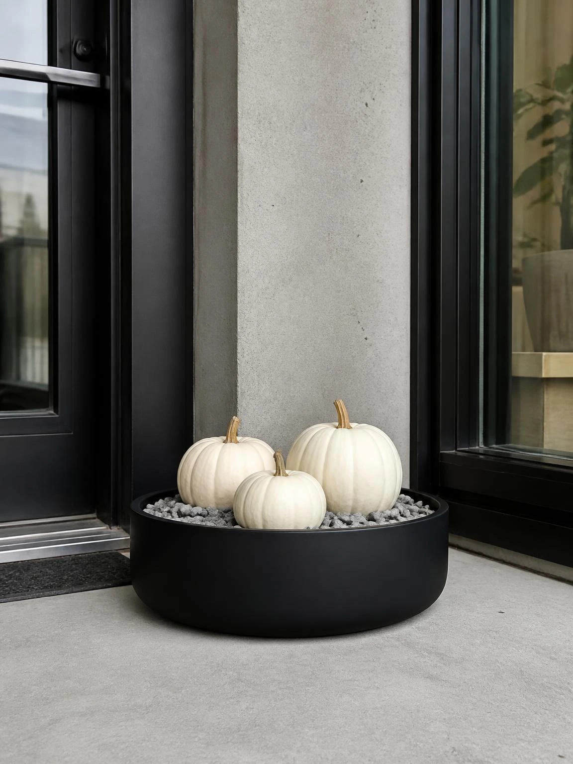 7- Matte Black Planter with White Pumpkins - halloween porch ideas for small spaces