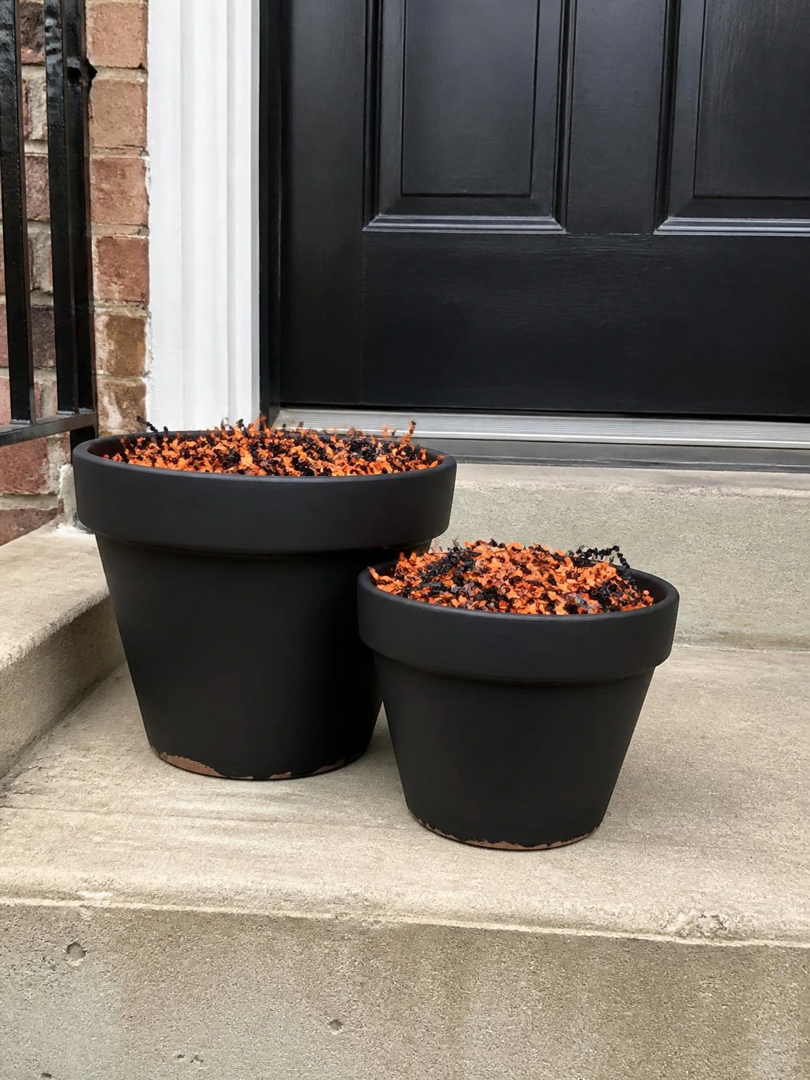 13- Painted Black Terracotta Pots as Cauldron Props - halloween porch ideas for small spaces