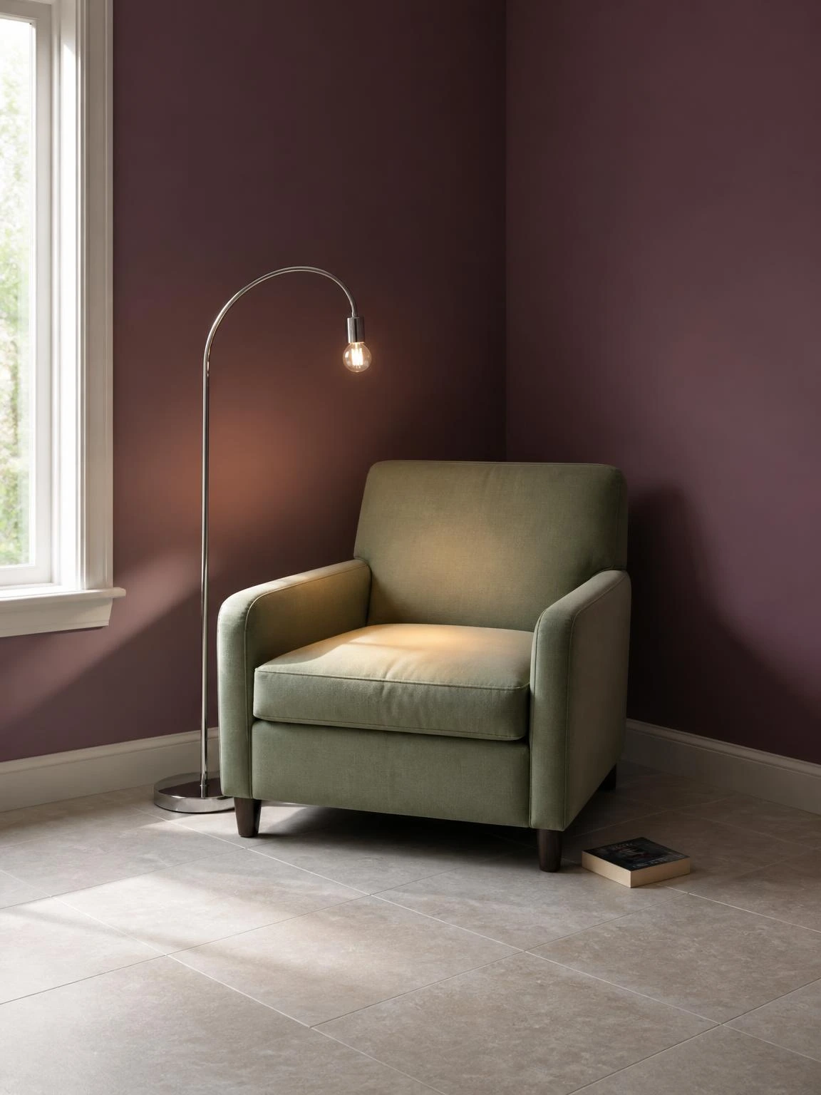 Plum-walled reading nook with a sage green chair and arc floor lamp in a minimal home decor corner setup