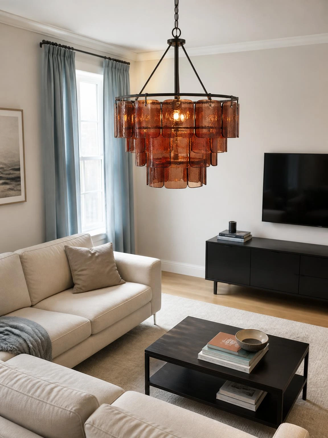 Rust-toned glass chandelier above a neutral sofa demonstrates a warm focal point for contemporary living room chandelier ideas