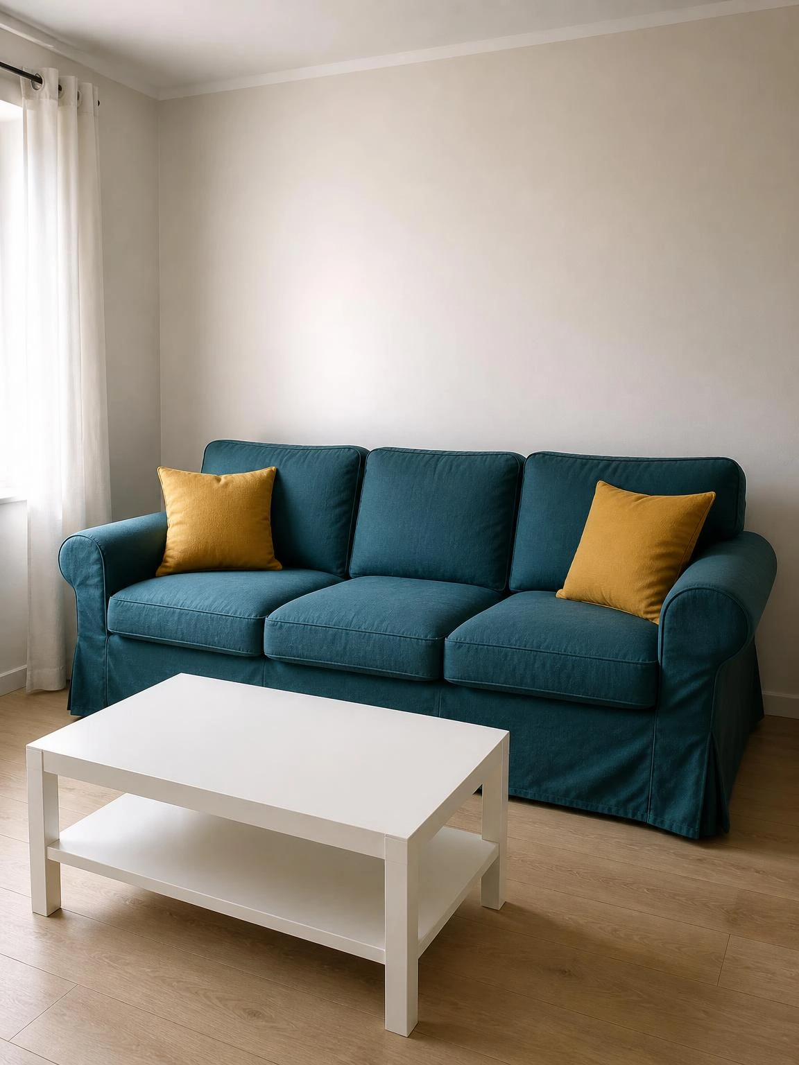 Deep teal linen slipcover on a three-seat sofa styled with mustard cushions in a compact bright living room summer refresh