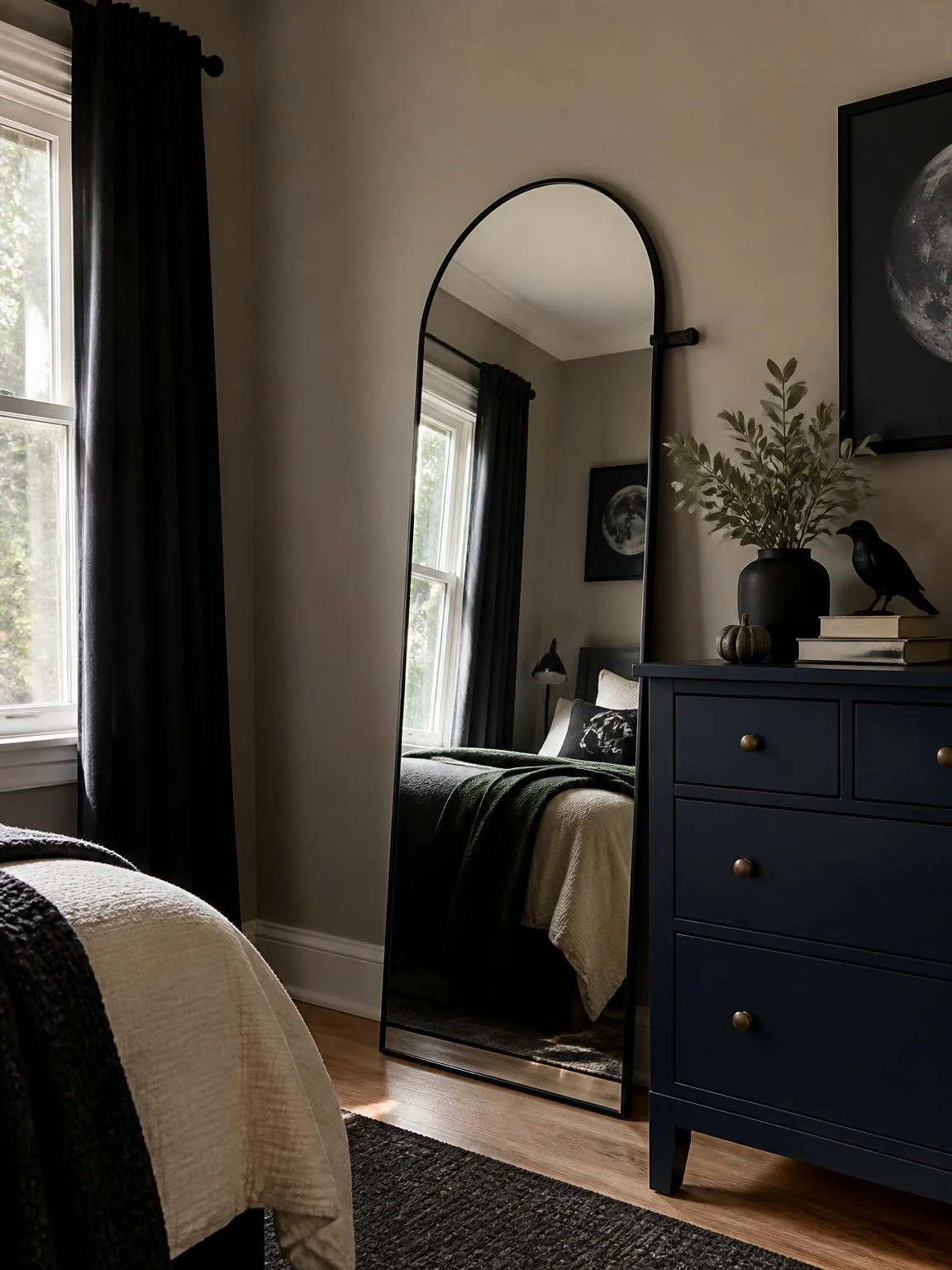 Tall arched mirror beside a navy dresser brightens a compact room in this halloween aesthetic bedroom decor setup